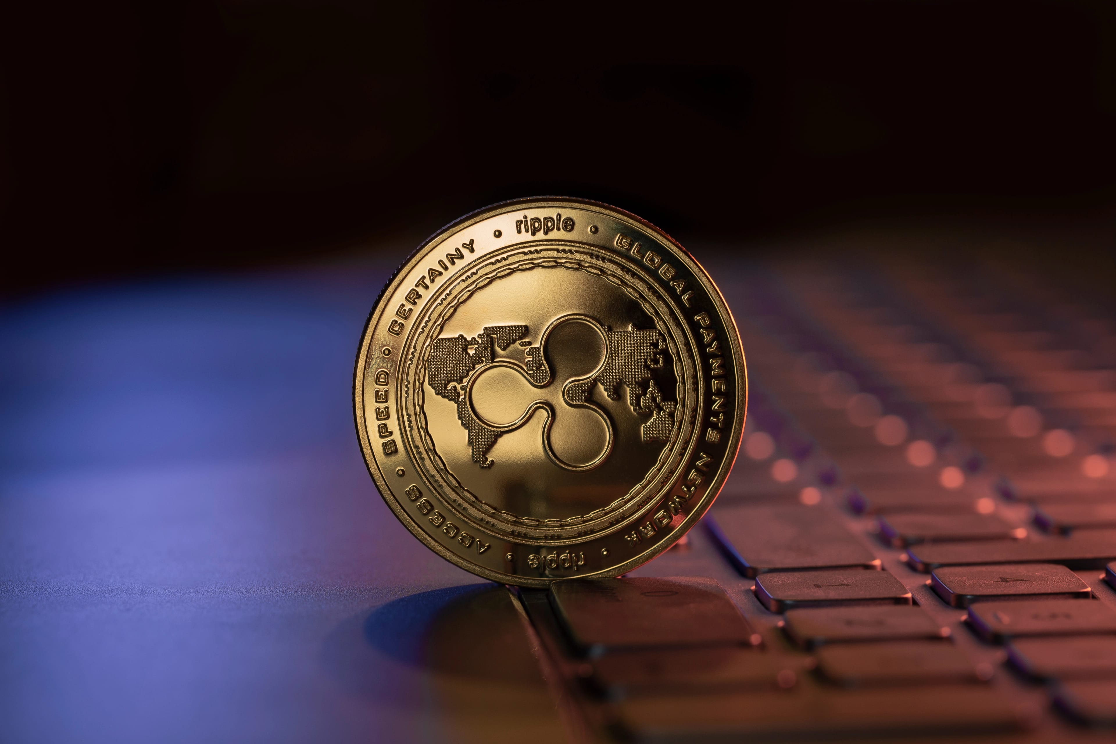 Ripple,Xrp,Cryptocurrency,Physical,Coin,Placed,On,Laptop,Keyboard,And
