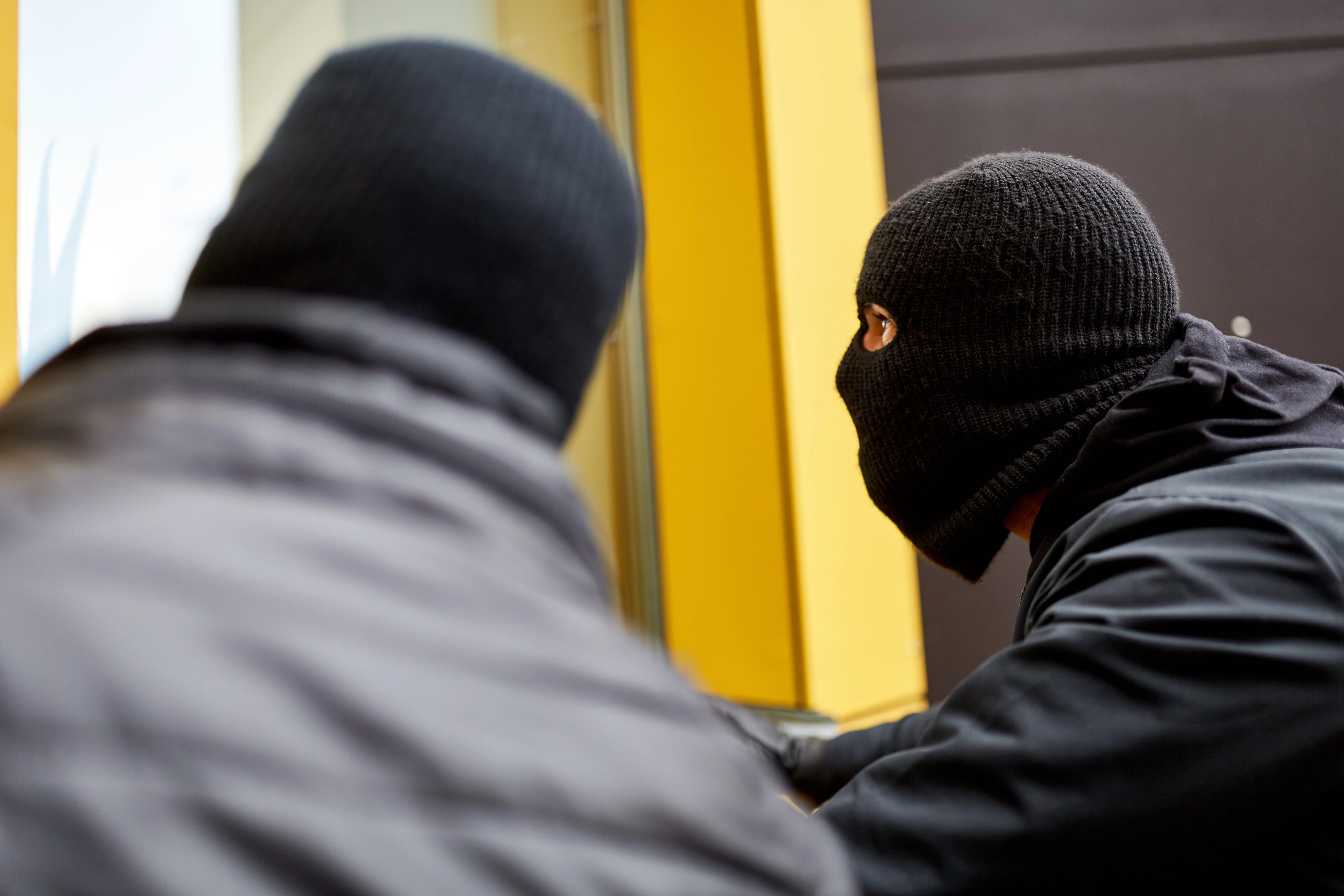 Two,Burglars,Quietly,Explore,A,House,Through,A,Window,For