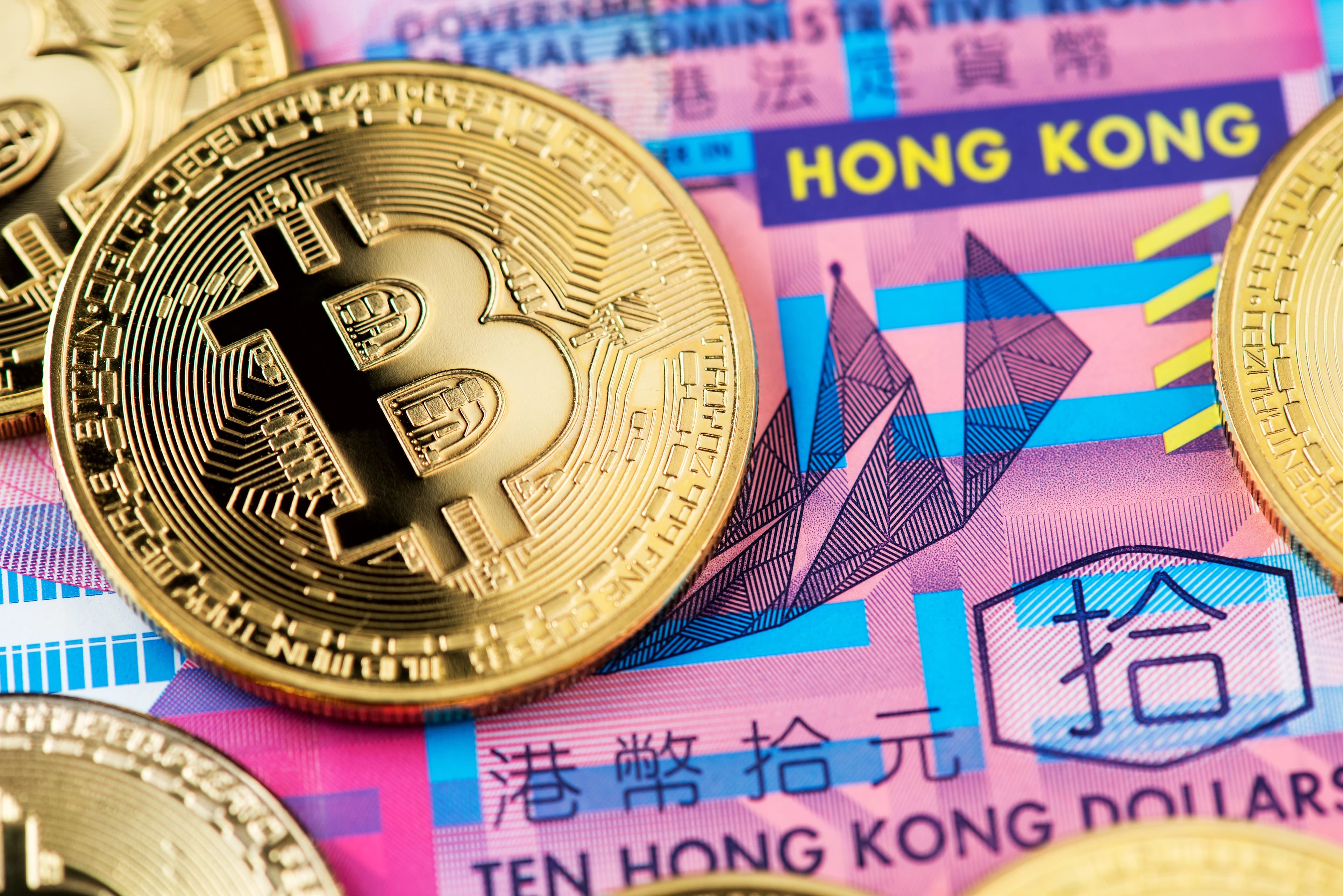 Bitcoin,Cryptocurrency,Coins,On,Hong,Kong,Dollar,Banknotes.