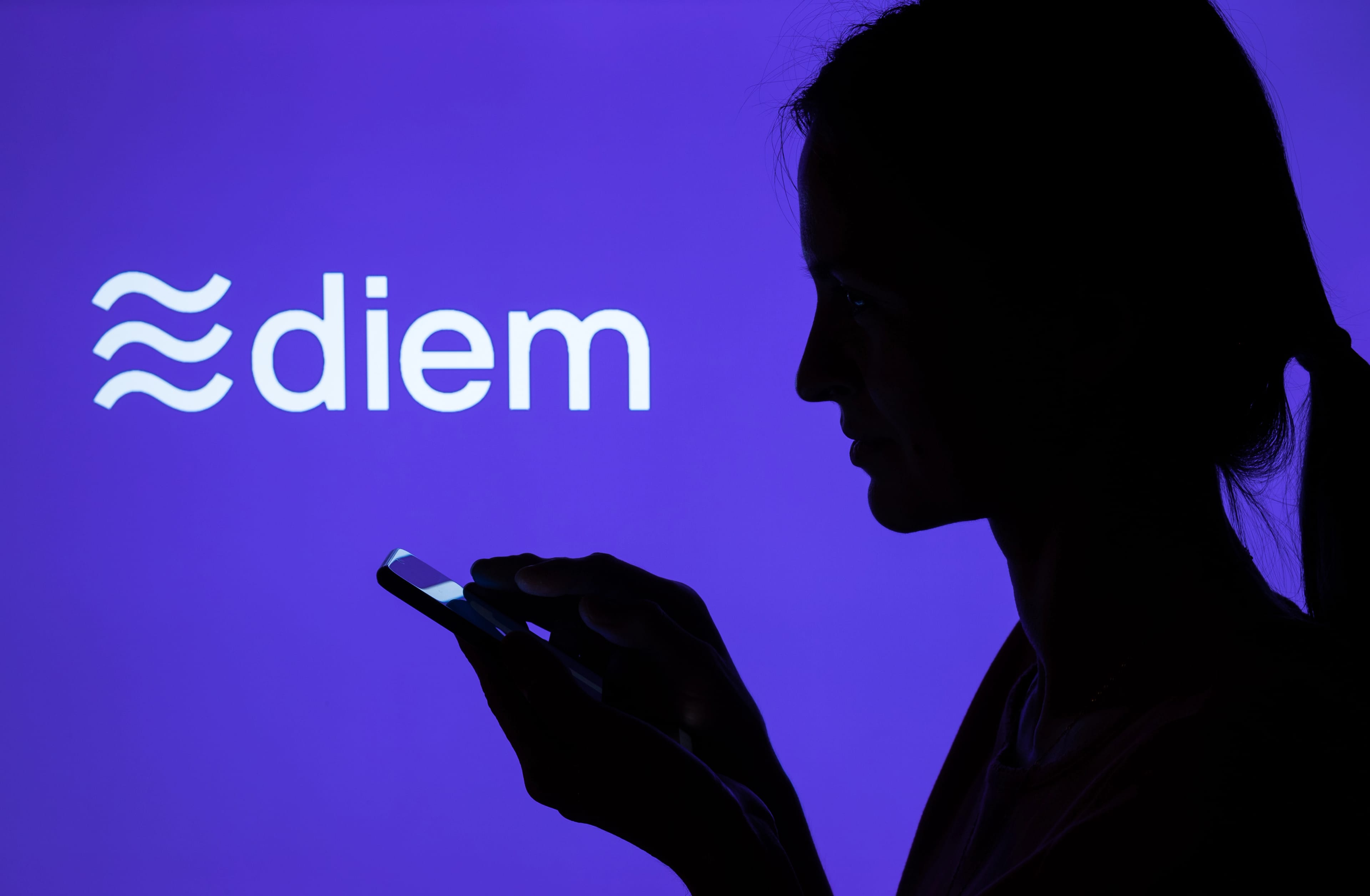 Silhouette,Of,A,Girl,With,Smartphone,And,Facebook,Diem,Cryptocurrency